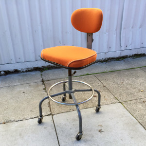 Newly upholstered orange industrial stool at midcenturysanjose